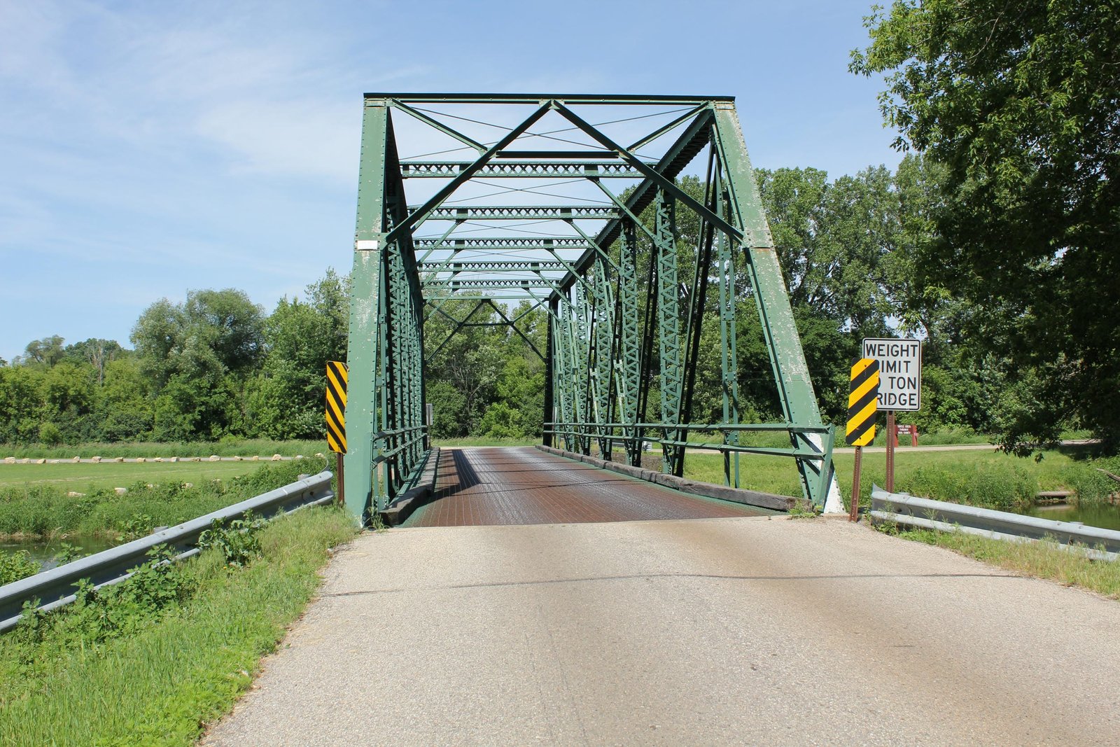 Looking east across nearby truss bridge, which has since been replaced and relocated to a private farm